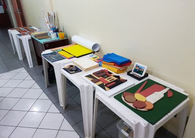 mesas com materiais da oficina a serem produzidos.
